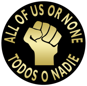 Black power fist surrounded by ALL OF US OR NONE and its Spanish translation TODOS O NADIE.